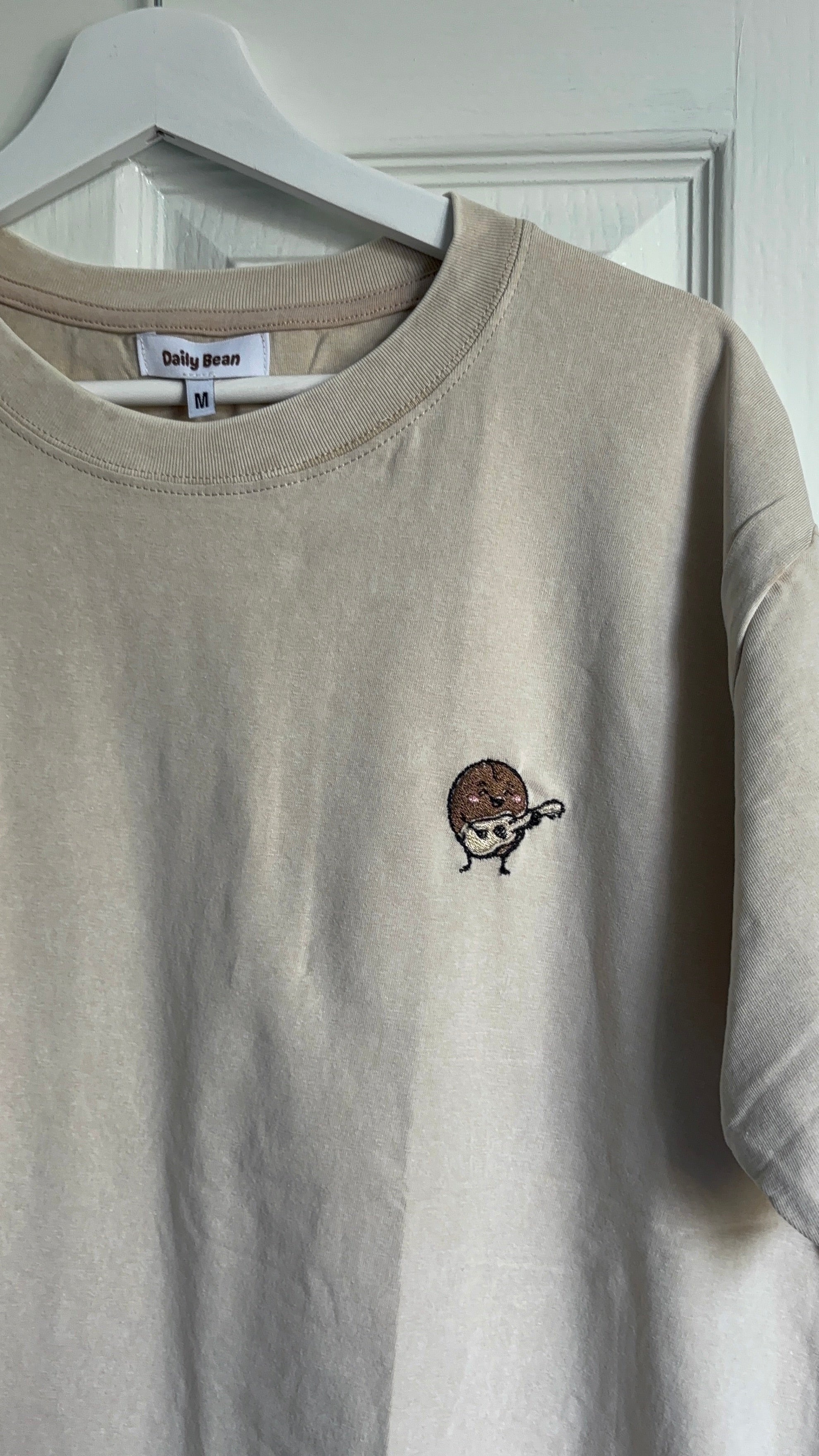 guitar custom beige t shirt  on hanger