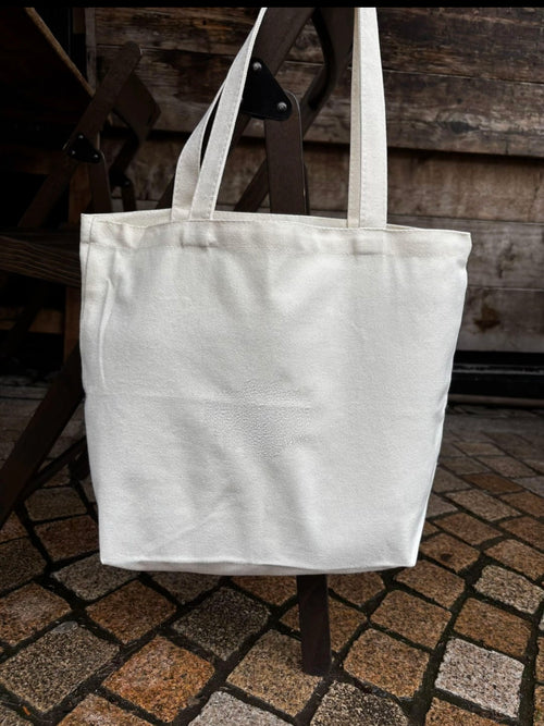 White tote bag on a wooden chair with a rustic background